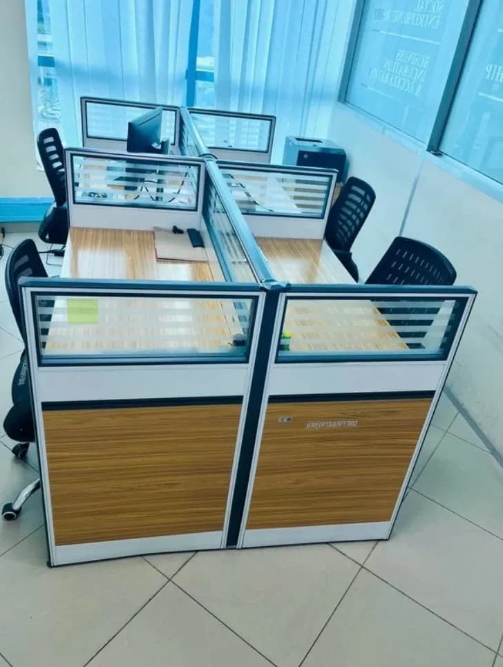 Shared workstations with partitions and ergonomic chairs at IMED HUB