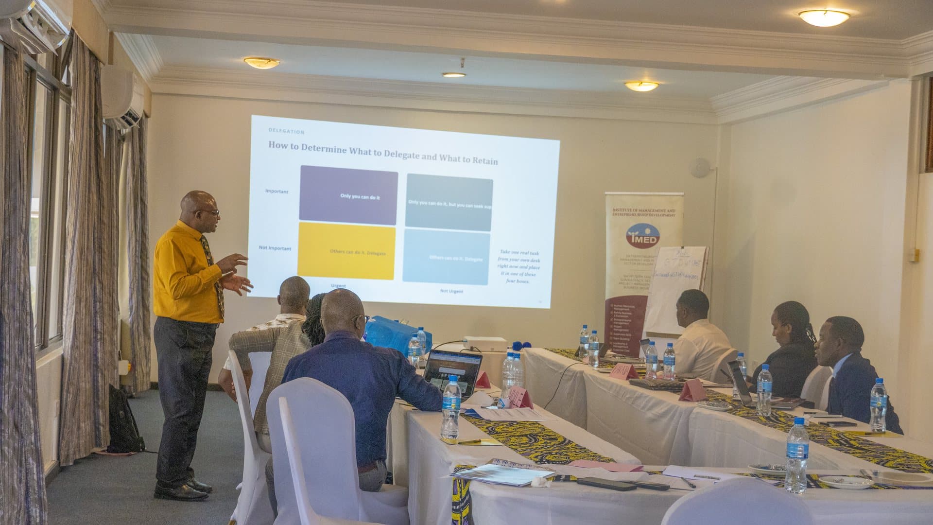 IMED facilitator leading a management training session for Muhimbili National Hospital participants